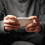 A man looking at his phone in landscape mode